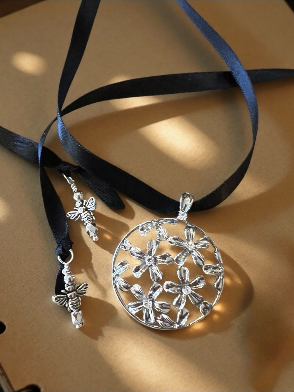 Silver Toned Floral Cutout Pendant Necklace on Black Satin Ribbon